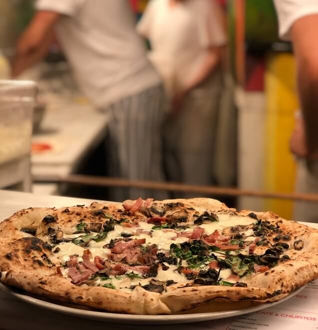 Pizza terminée par les chefs pizzaiolos en attendant d'être amenée en salle