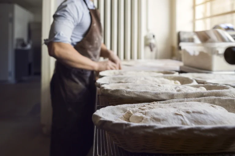Un homme qui prépare du pain dans une cuisine